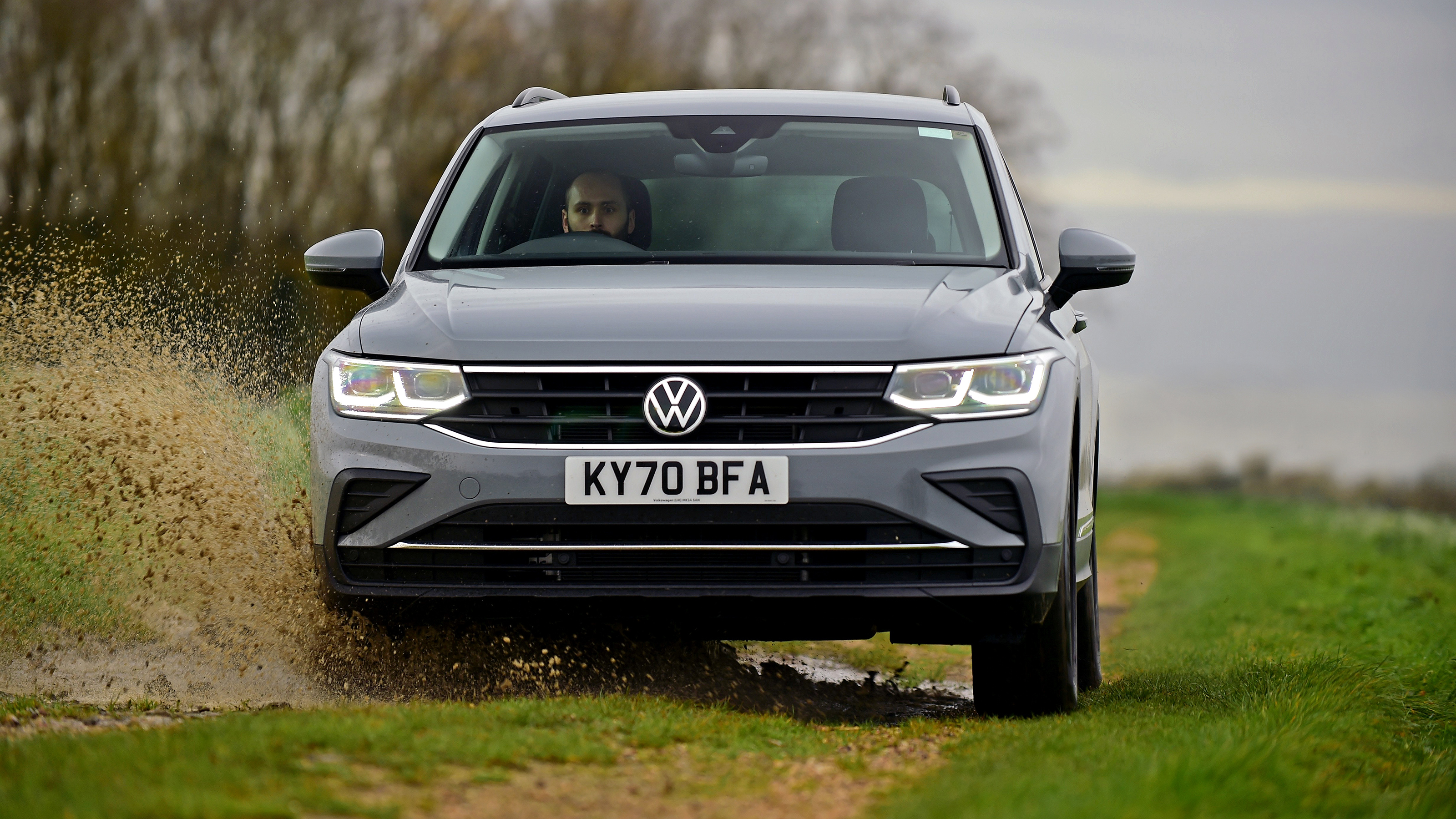 VW Tiguan driving through mud