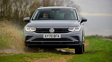 VW Tiguan driving through mud