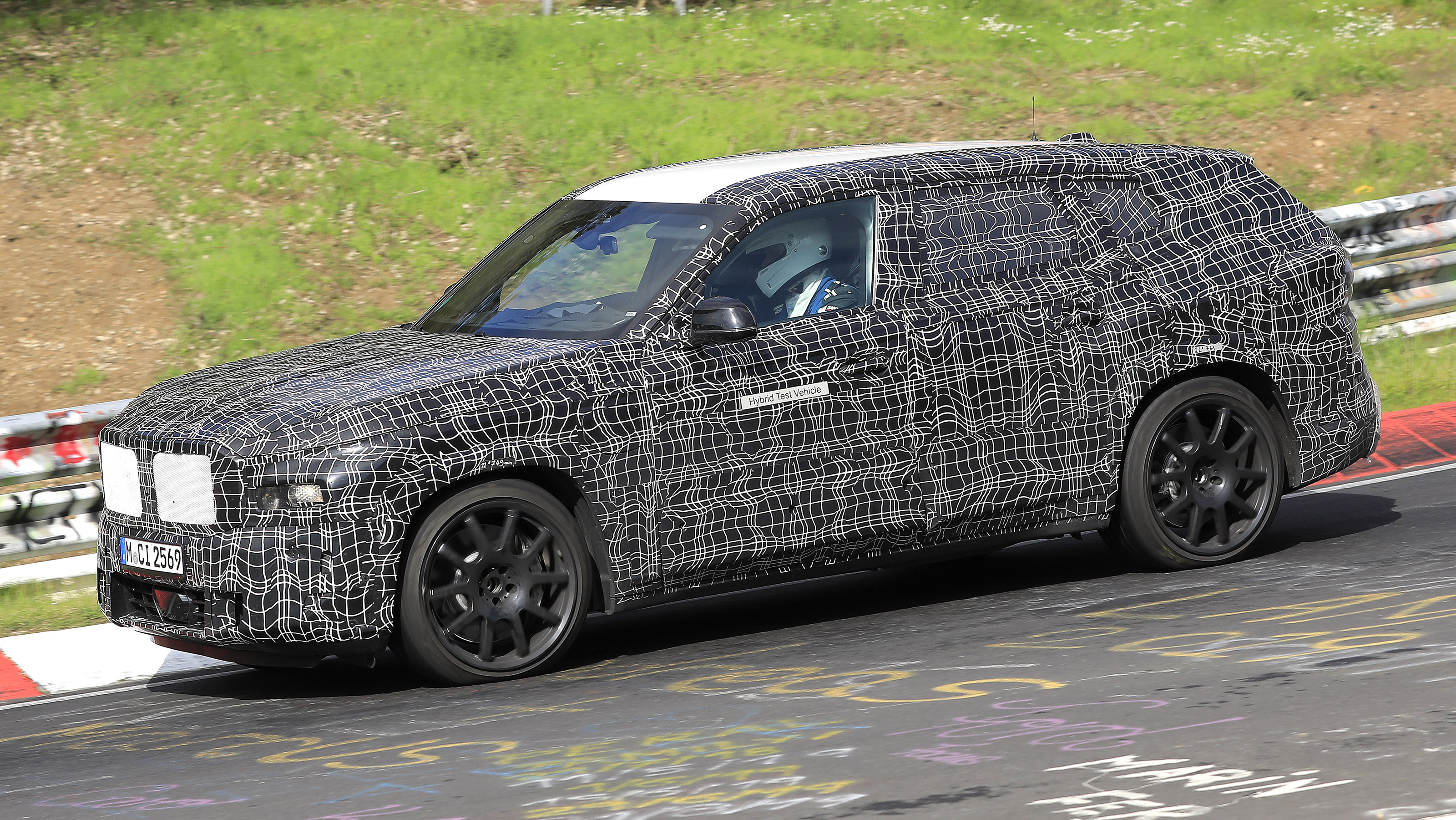 2022 BMW X8 SUV prototype - front side on passing