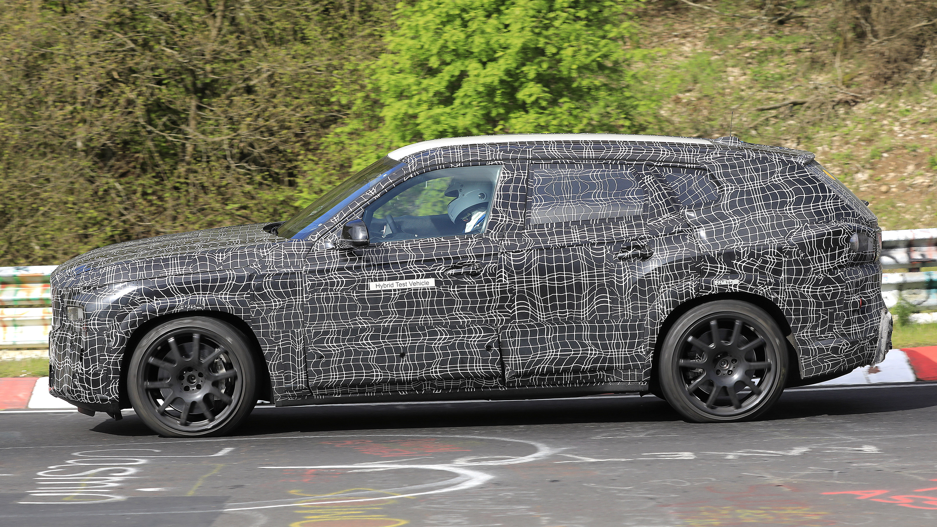 2022 BMW X8 SUV prototype - side on passing 
