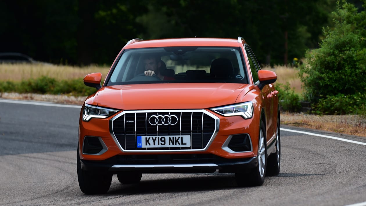 Orange Audi Q3 driving - front