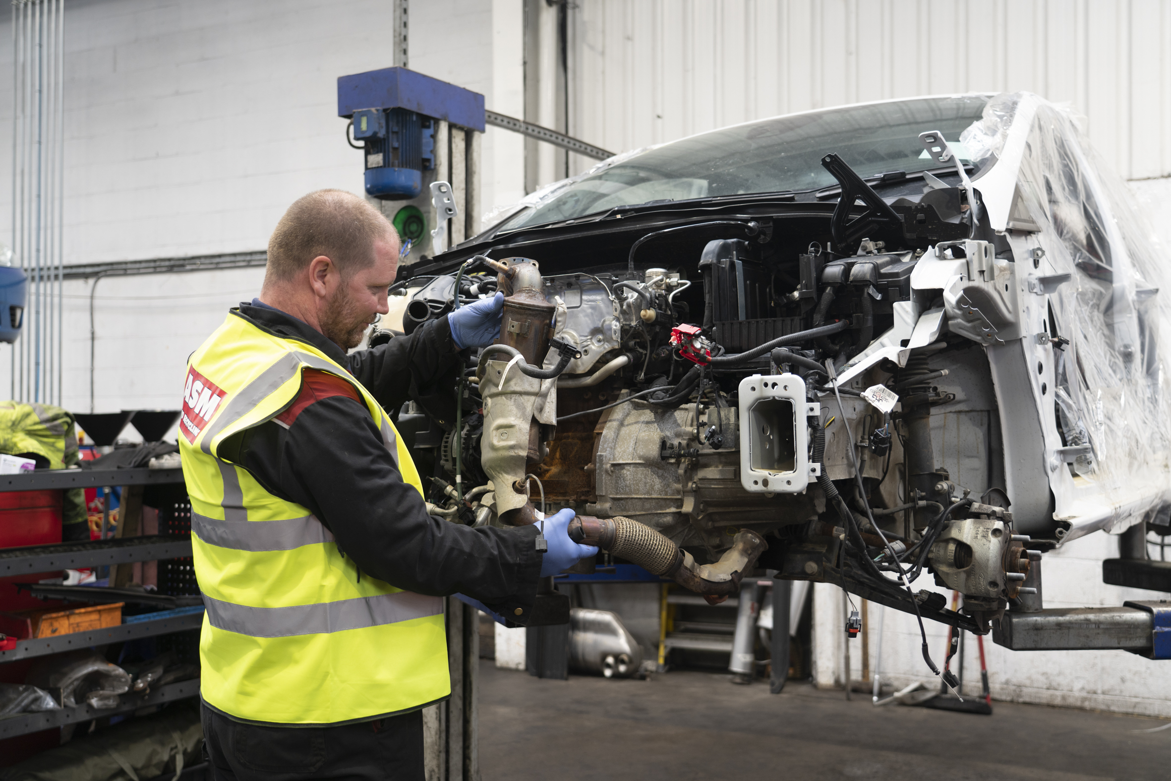 Mechanic dismantling car