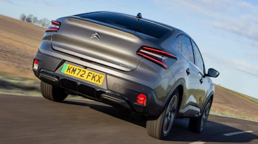 Citroen e-C4 X saloon rear 3/4 tracking