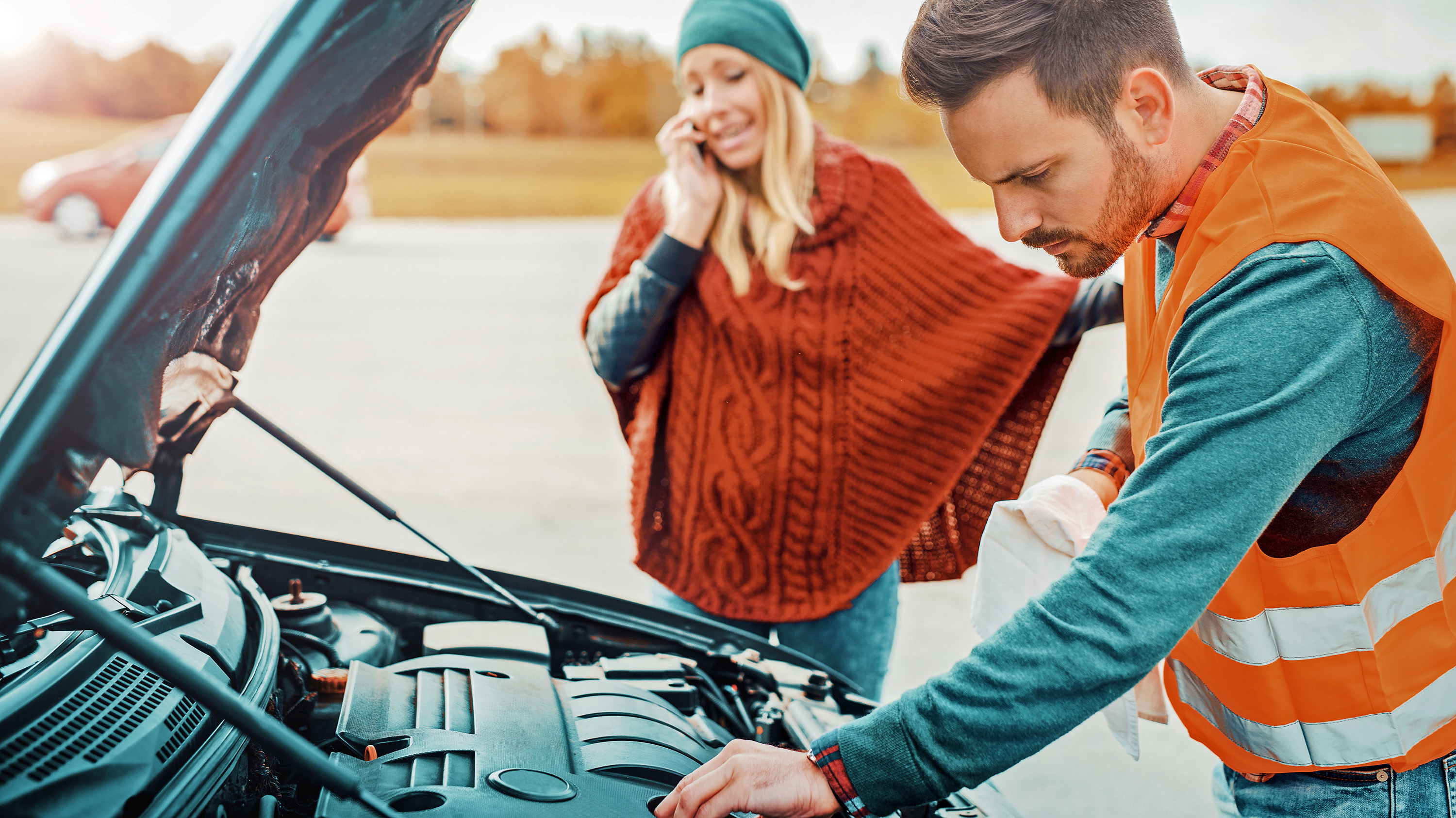 Breakdown technician working on car