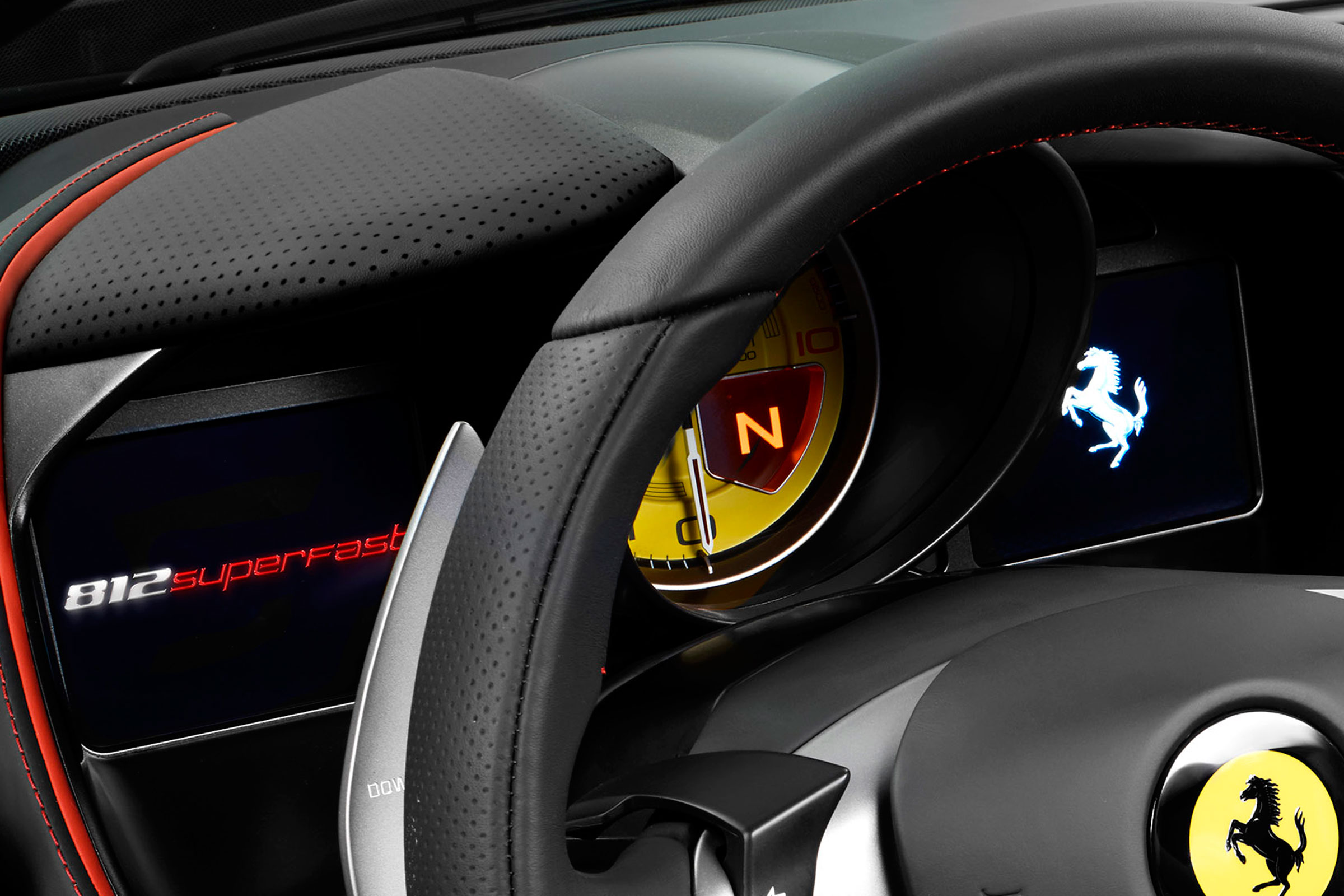The dashboard screens are configurable, but dominated by a huge yellow dial