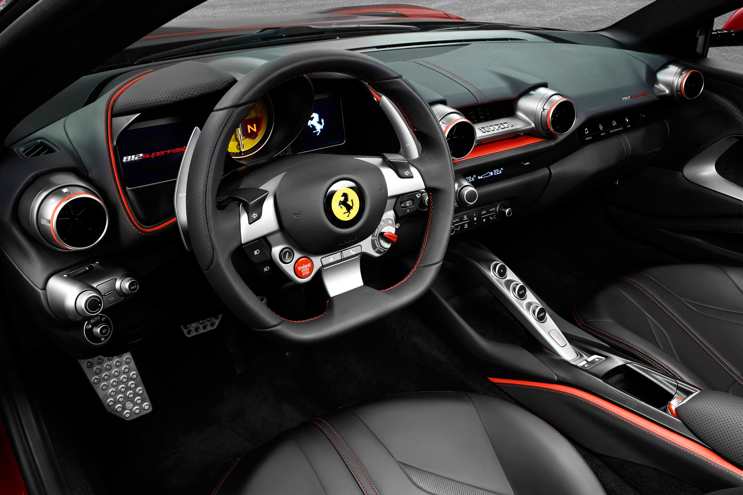 The interior features the familiar Ferrari controls and myriad screens in front of the driver