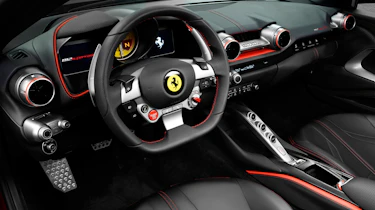 The interior features the familiar Ferrari controls and myriad screens in front of the driver