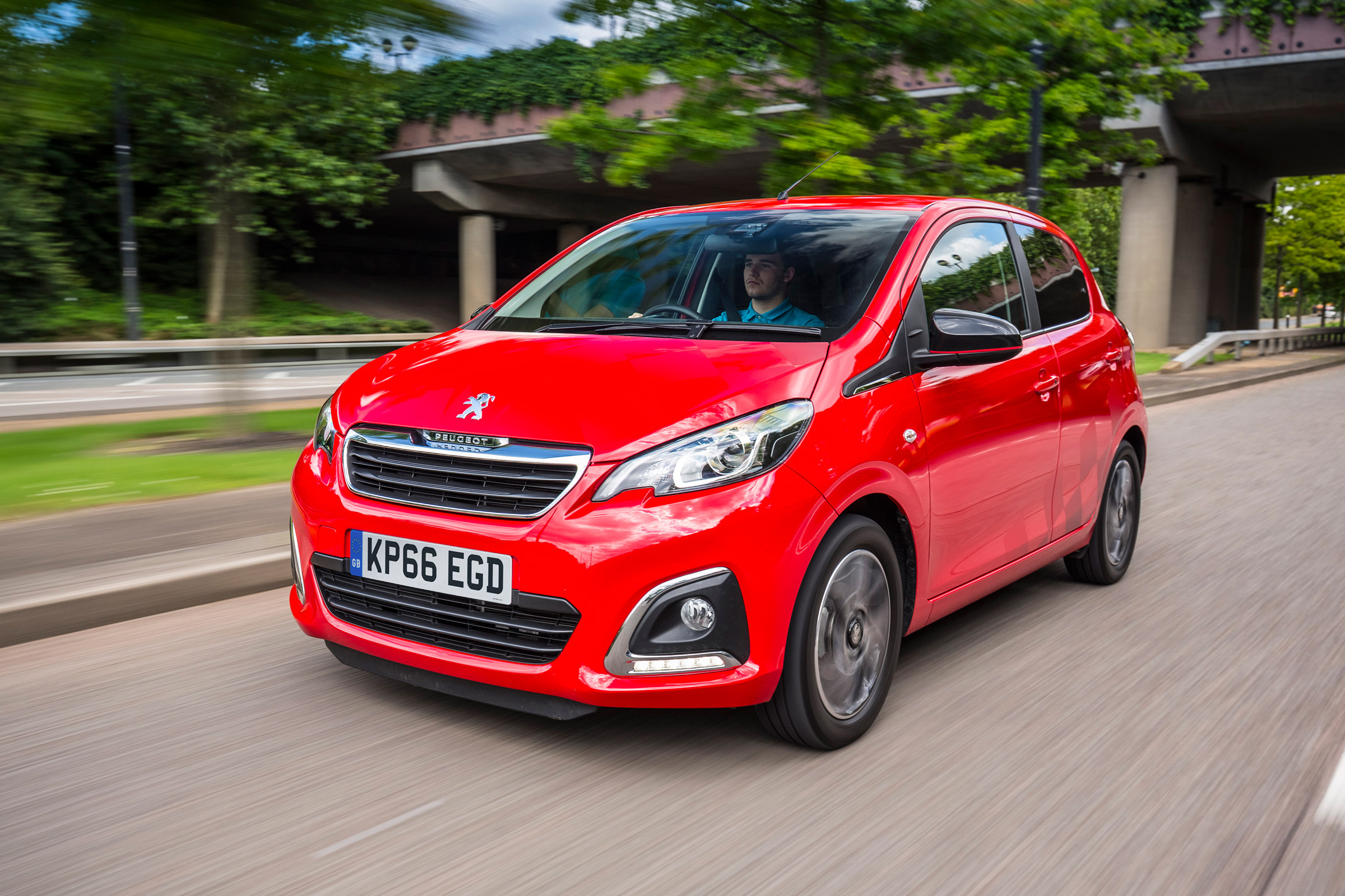 Red Peugeot 108 driving