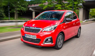 Red Peugeot 108 driving