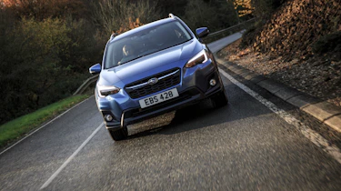 A raised ground clearance, plastic wheelarch cladding and roof rails add to its SUV design cues