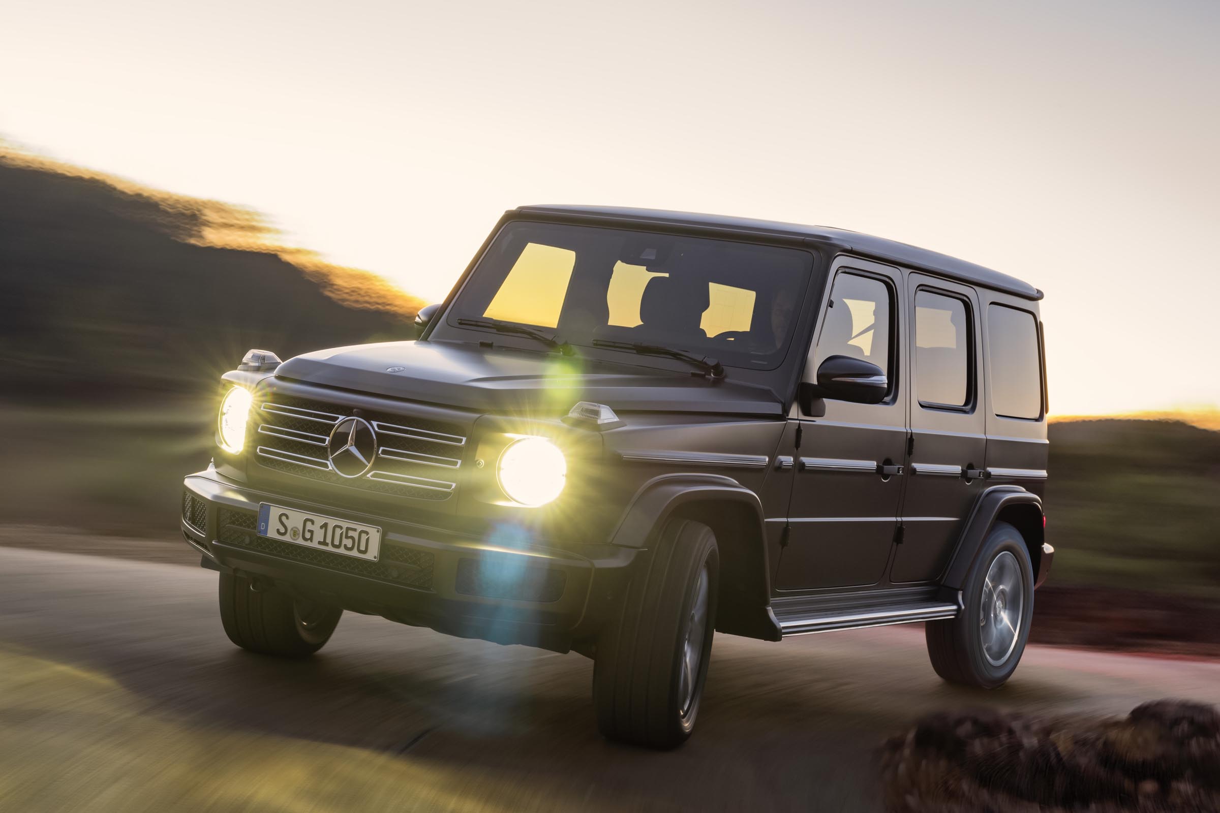 Mercedes G-Class driving with headlights on