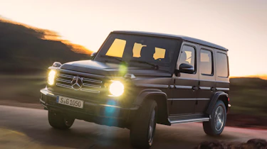 Mercedes G-Class driving with headlights on