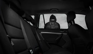 Car thief looking into car