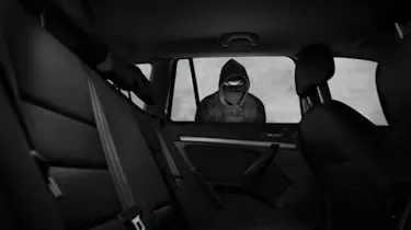 Car thief looking into car