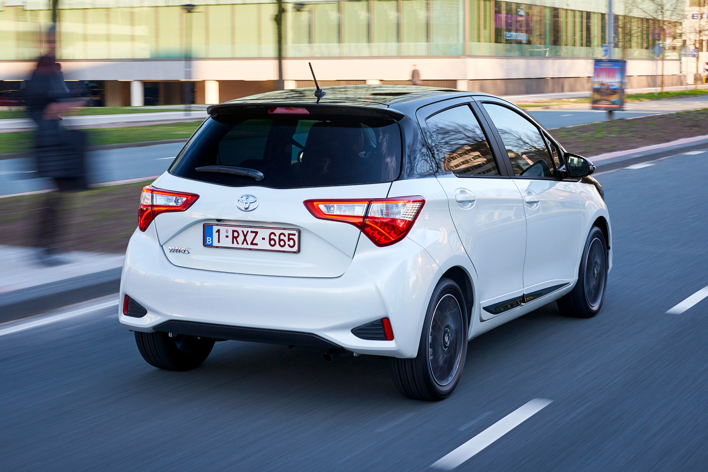 Toyota Yaris driving in city - rear view