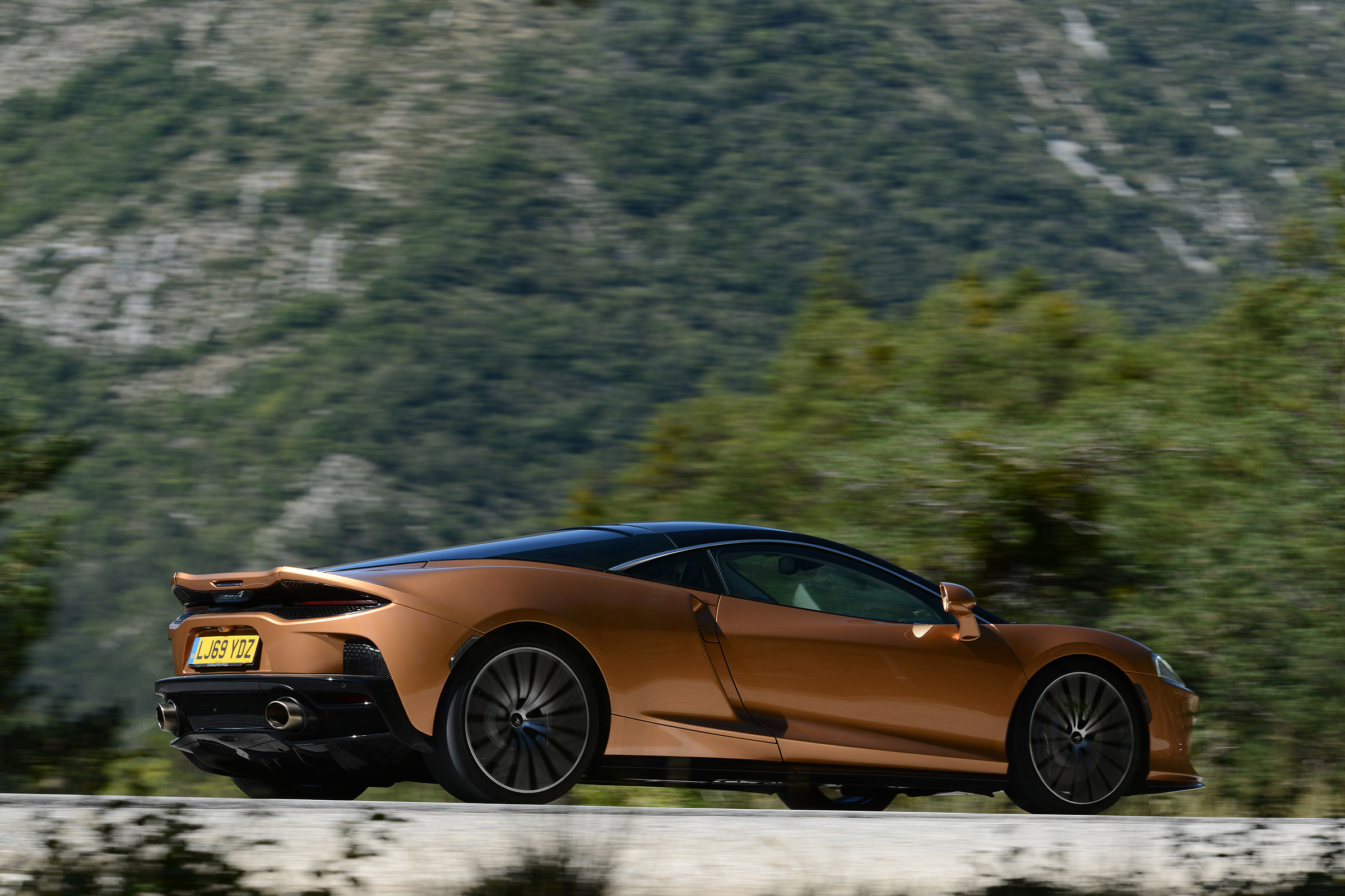 McLaren GT driving past camera