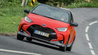 Toyota Yaris driving on road