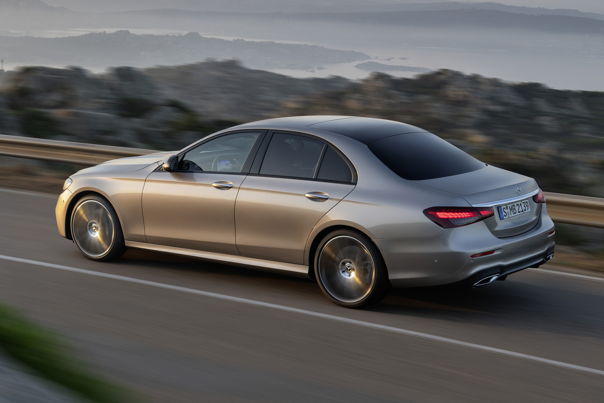 Mercedes E-Class driving with lights on - rear 
