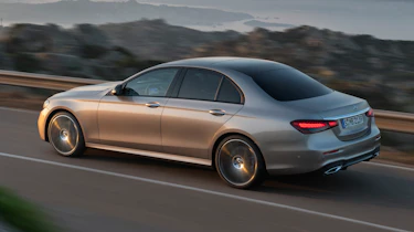 Mercedes E-Class driving with lights on - rear