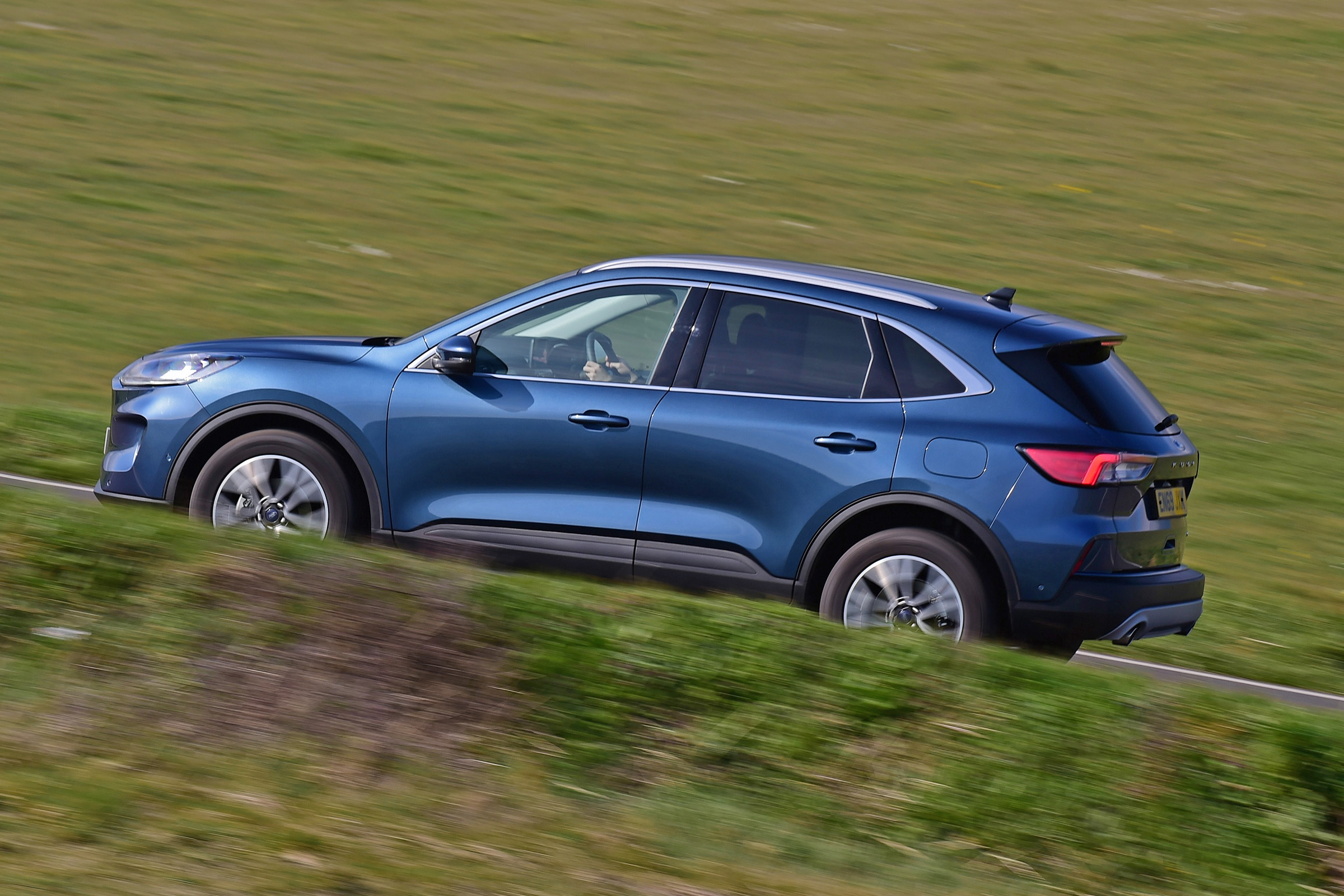 Ford Kuga driving up hill - side view
