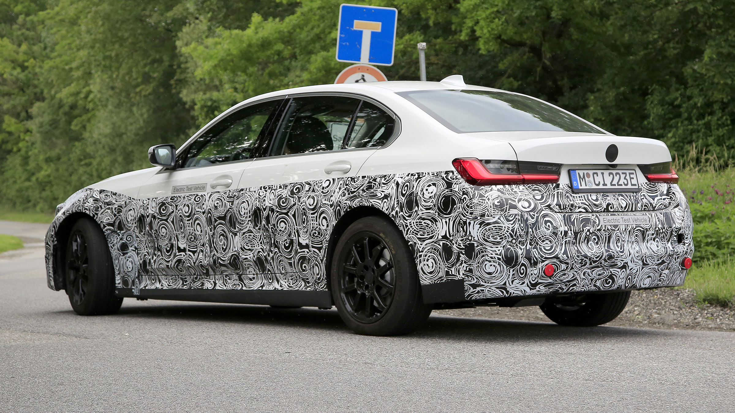 Electric BMW 3 Series driving - rear side view