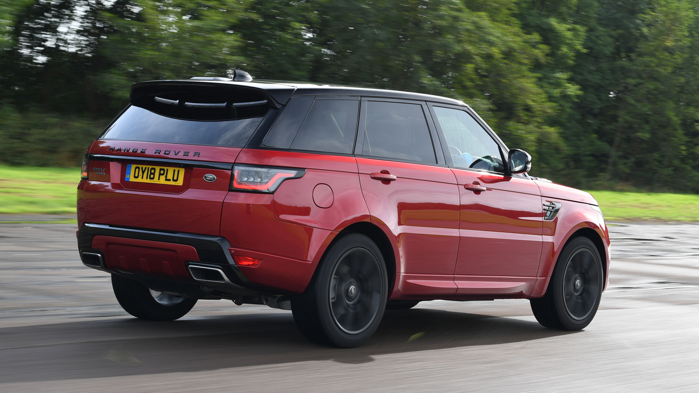 Range Rover Sport SUV driving rear view