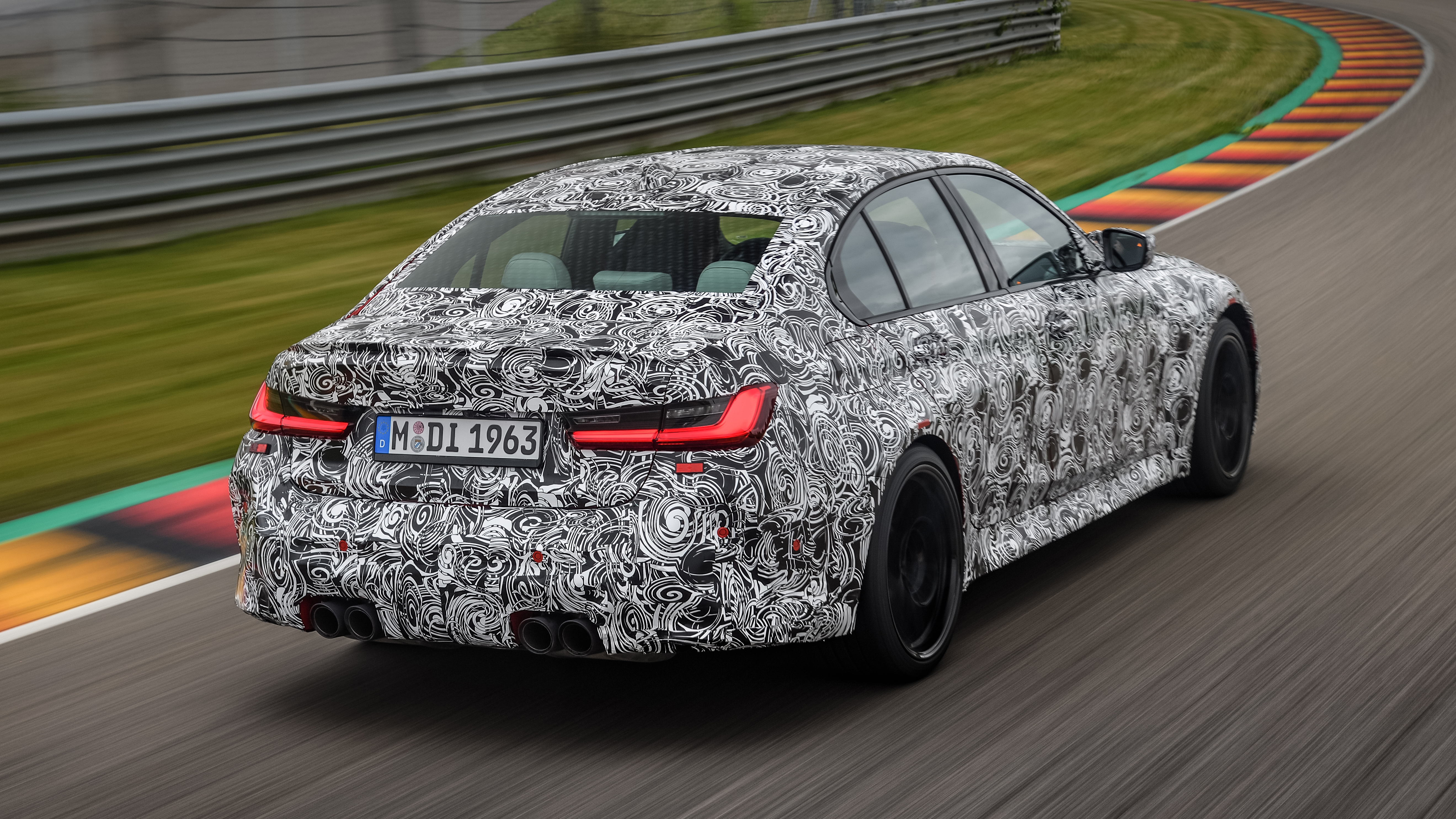2020 BMW M3 saloon prototype - rear 3/4 view passing 