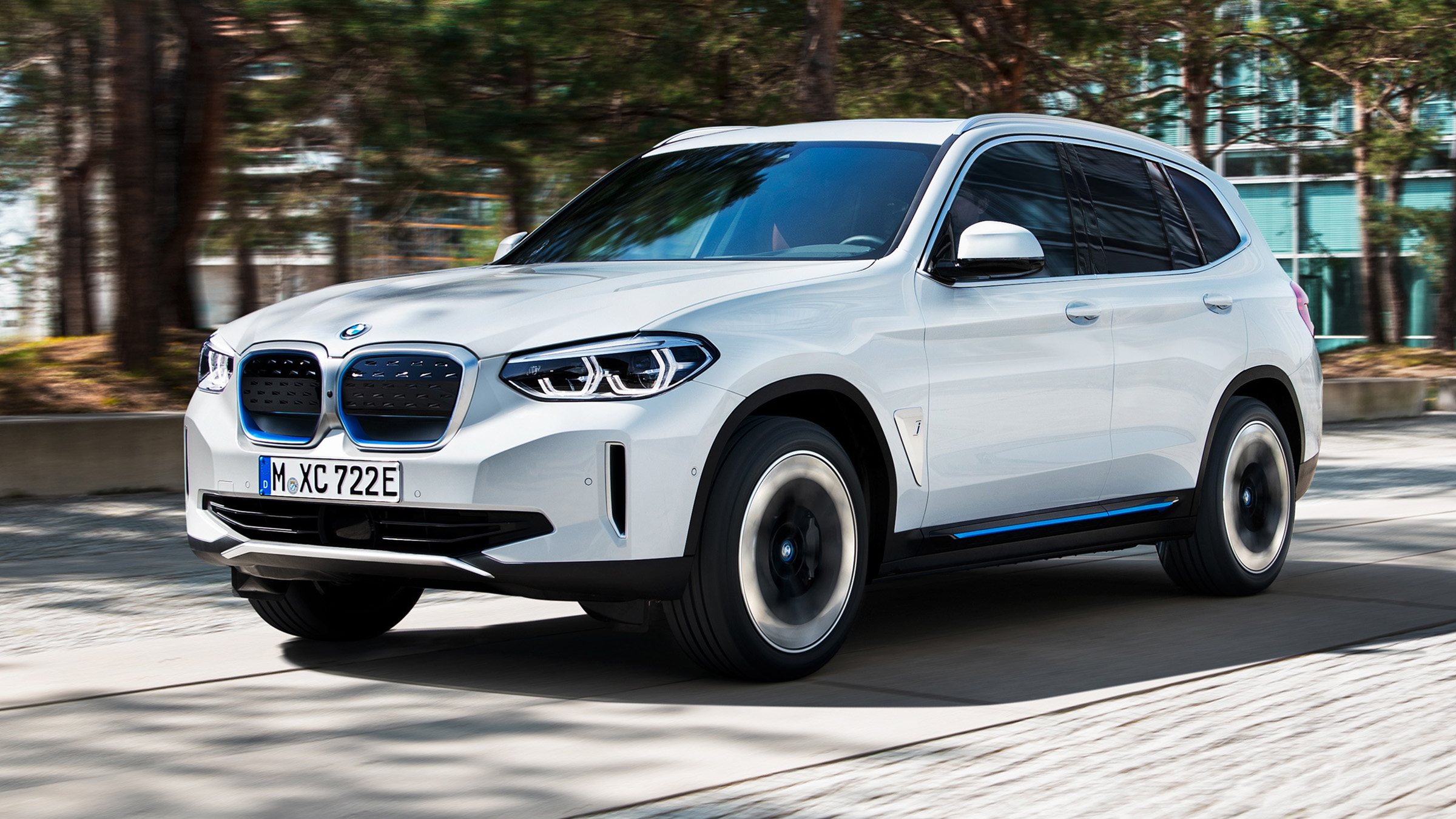 BMW iX3 driving through city