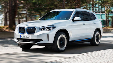 BMW iX3 driving through city