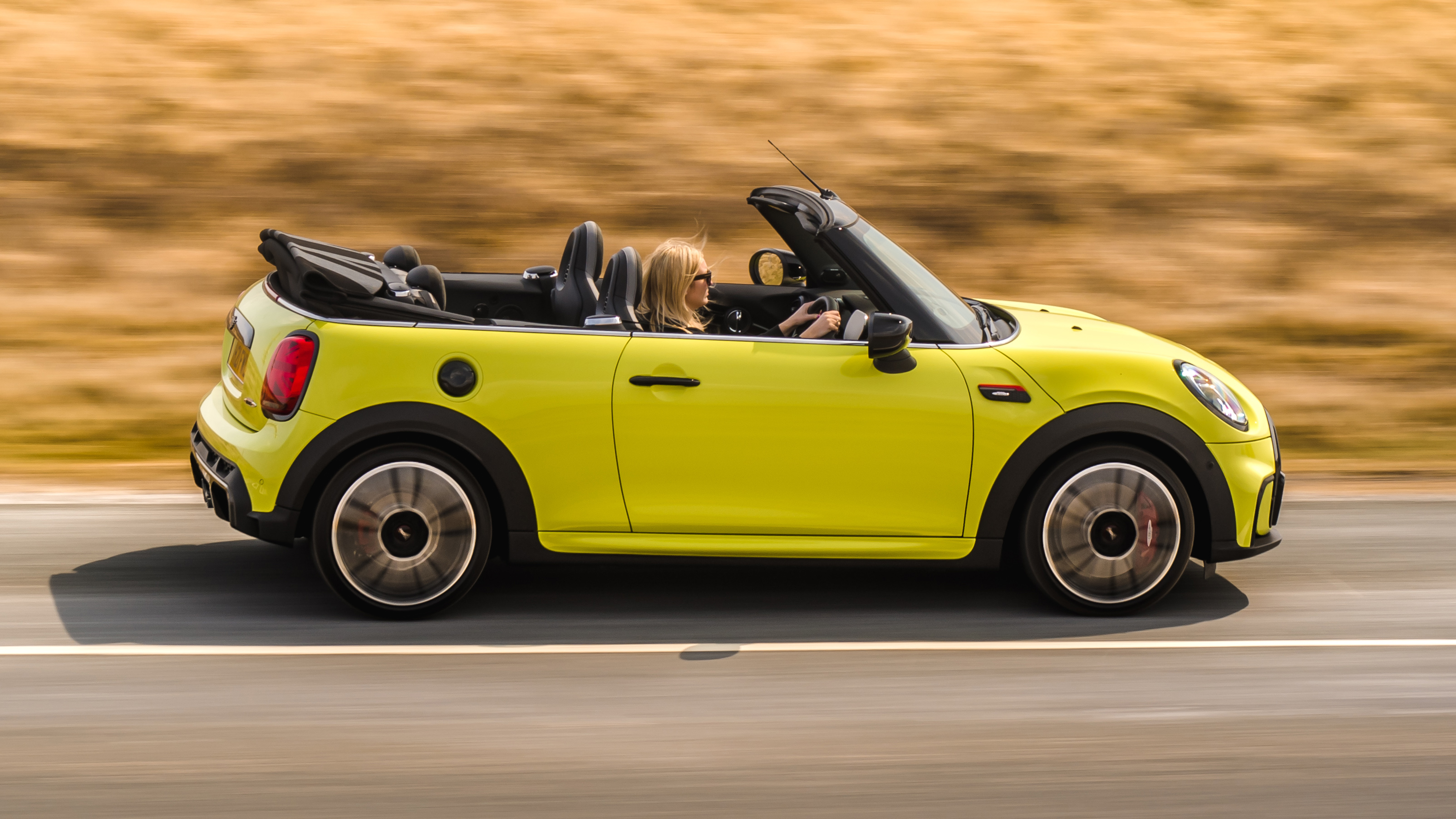 2021 MINI Convertible driving with roof down - side view