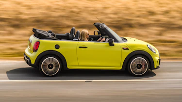 2021 MINI Convertible driving with roof down - side view