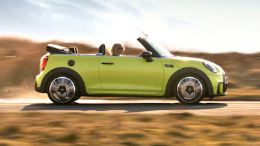 2021 MINI Convertible driving along road - side view