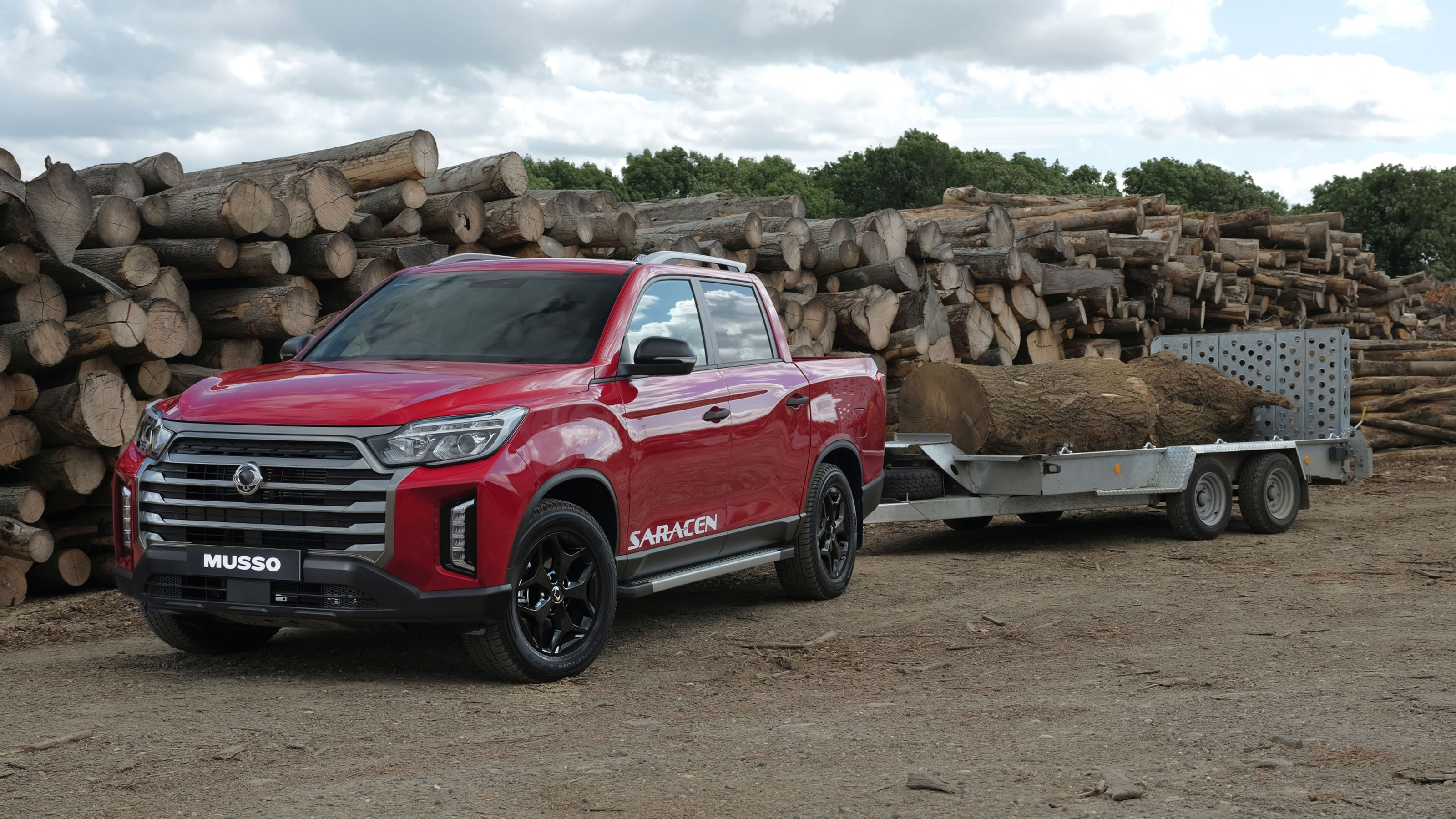 SsangYong Musso facelift towing a trailer full of logs