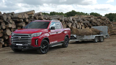 SsangYong Musso facelift towing a trailer full of logs
