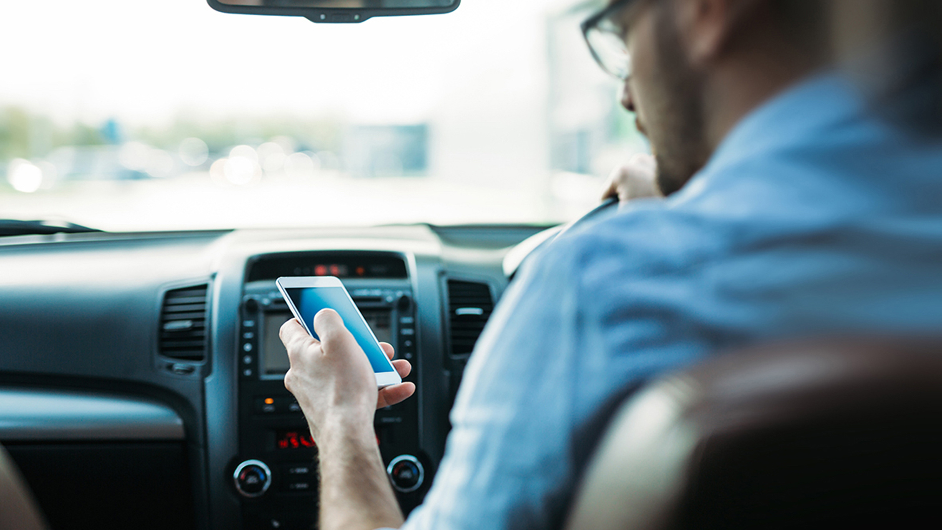 Driver using a phone behind the wheel