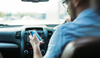 Driver using a phone behind the wheel
