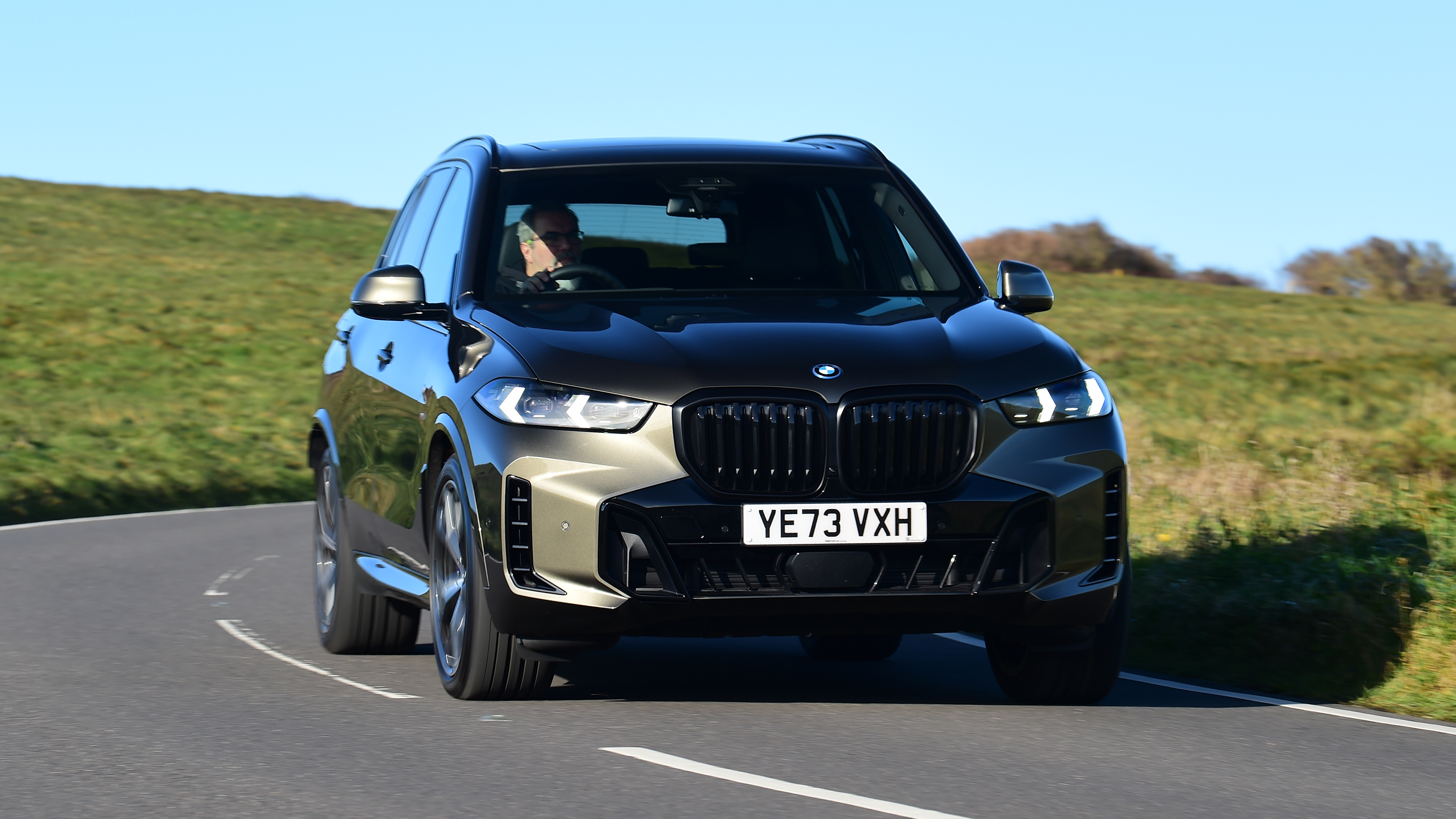 BMW X5 driving front long shot
