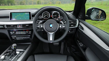 The cabin is dominated by a 10-inch infotainment screen controlled by BMW's iDrive controller
