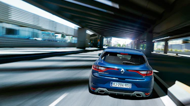 The GT model features trapezoidal exhaust pipes integrated with the rear bumper and unique 18-inch alloy wheels.