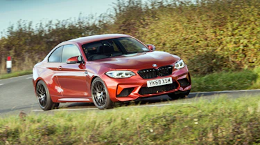 Orange BMW M2 driving